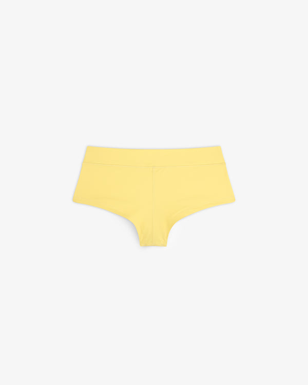 Crest Swim Short in yellow, seamless boyshort style, displayed flat on a white background.