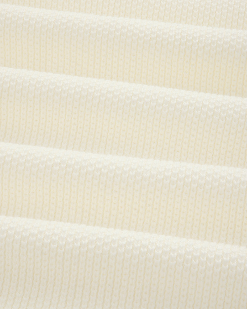Close-up of ALD Golf Piqué Full Zip Sweater’s white ribbed knit with evenly spaced horizontal ridges.