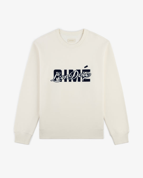 Ivory Overlay Logo Crewneck Sweatshirt with bold, dark blue Aimé Leon Dore logo across the chest.