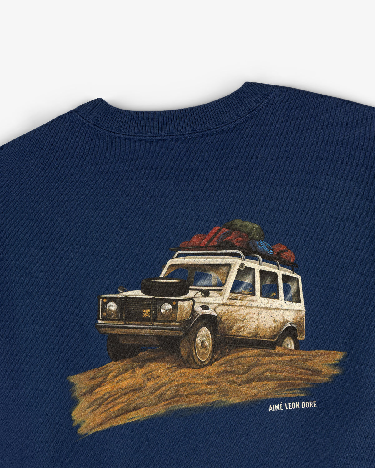 Safari Crewneck Sweatshirt in navy featuring a graphic loaded off-road vehicle and Aimé Leon Dore text underneath.
