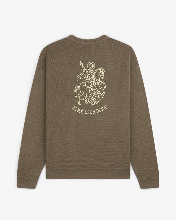 Saint George Piqué Crewneck Sweatshirt: Brown, long-sleeve with knight graphic and AIMÉ LEON DORE on the back.