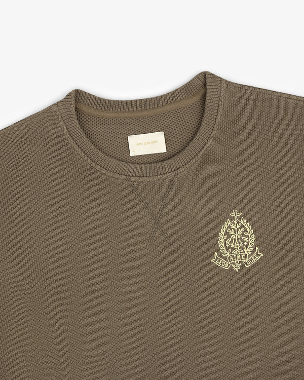 Olive green Saint George Piqué Crewneck Sweatshirt with crest emblem on chest and beige collar label.