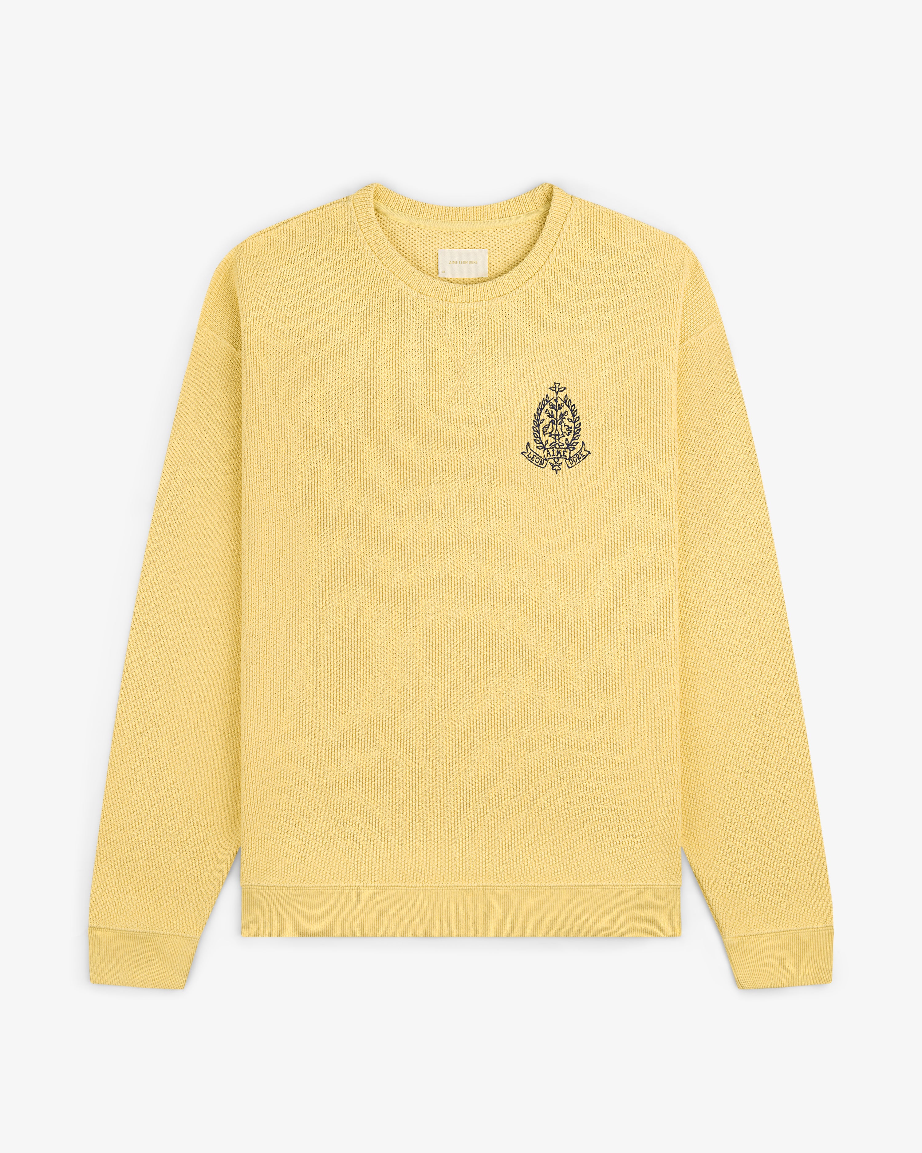 Saint George Piqué Crewneck Sweatshirt in yellow with a small black crest embroidered on the left chest.