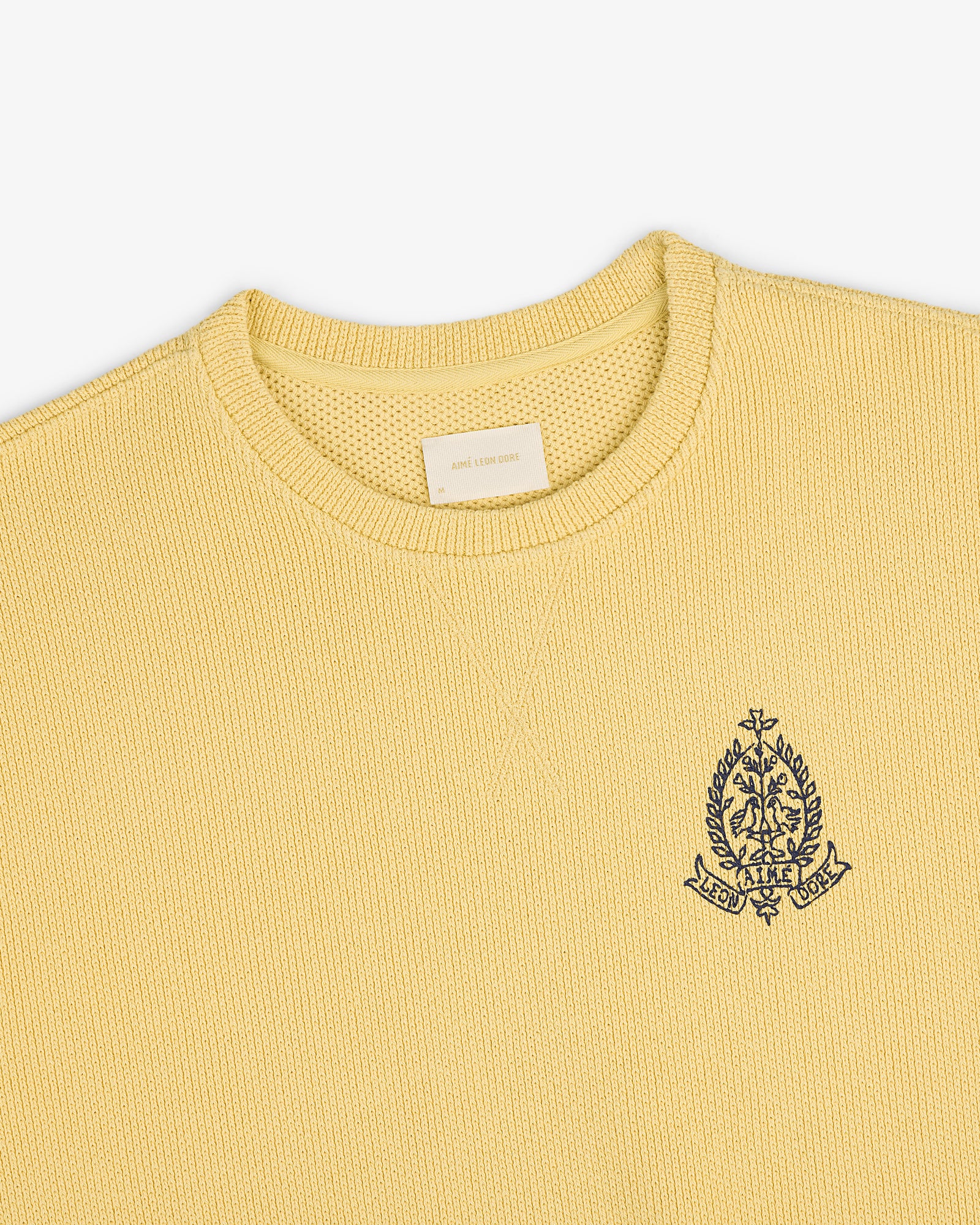 Saint George Piqué Crewneck Sweatshirt in yellow with textured knit and embroidered crest emblem on the left chest.