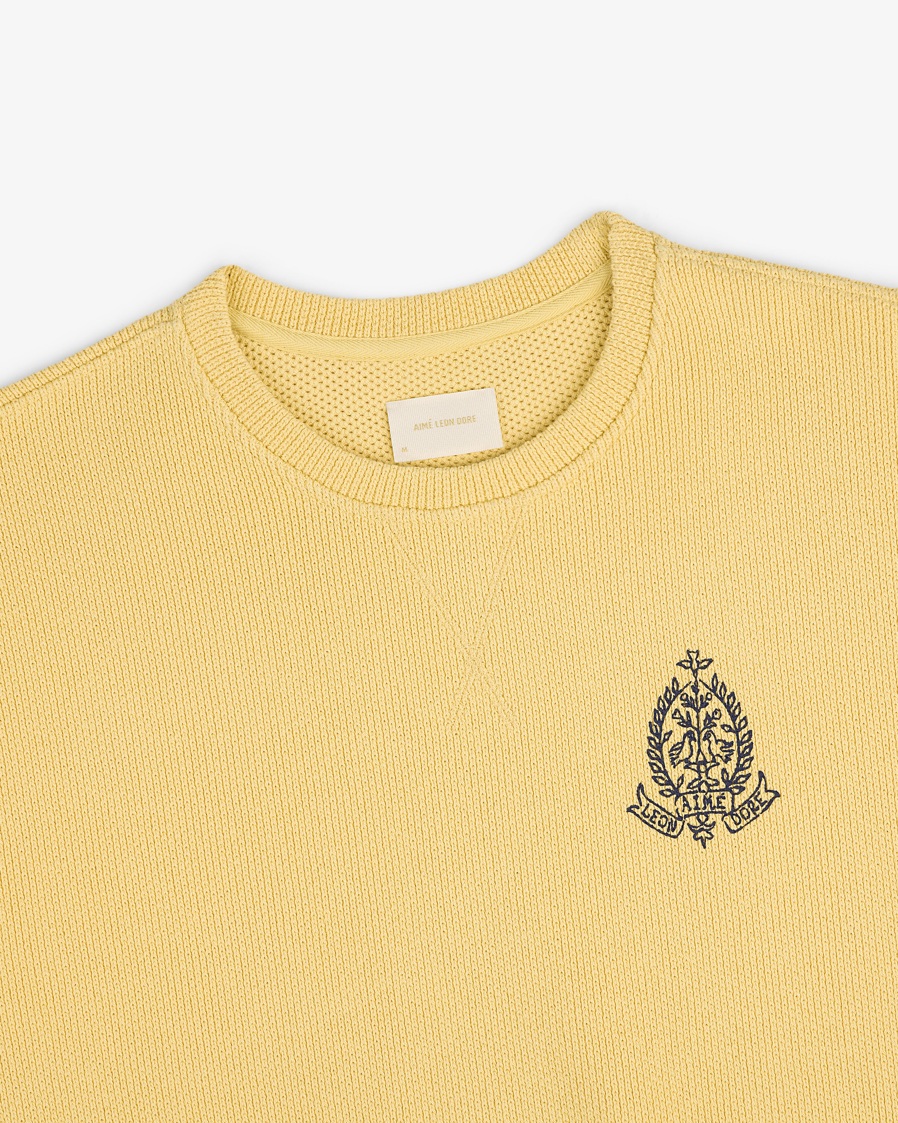 Saint George Piqué Crewneck Sweatshirt in yellow with textured knit and embroidered crest emblem on the left chest.