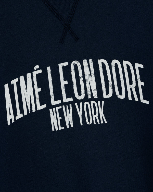 Navy Vintage Washed Crewneck Sweatshirt with distressed white AIMÉ LEON DORE NEW YORK in bold, curved letters.