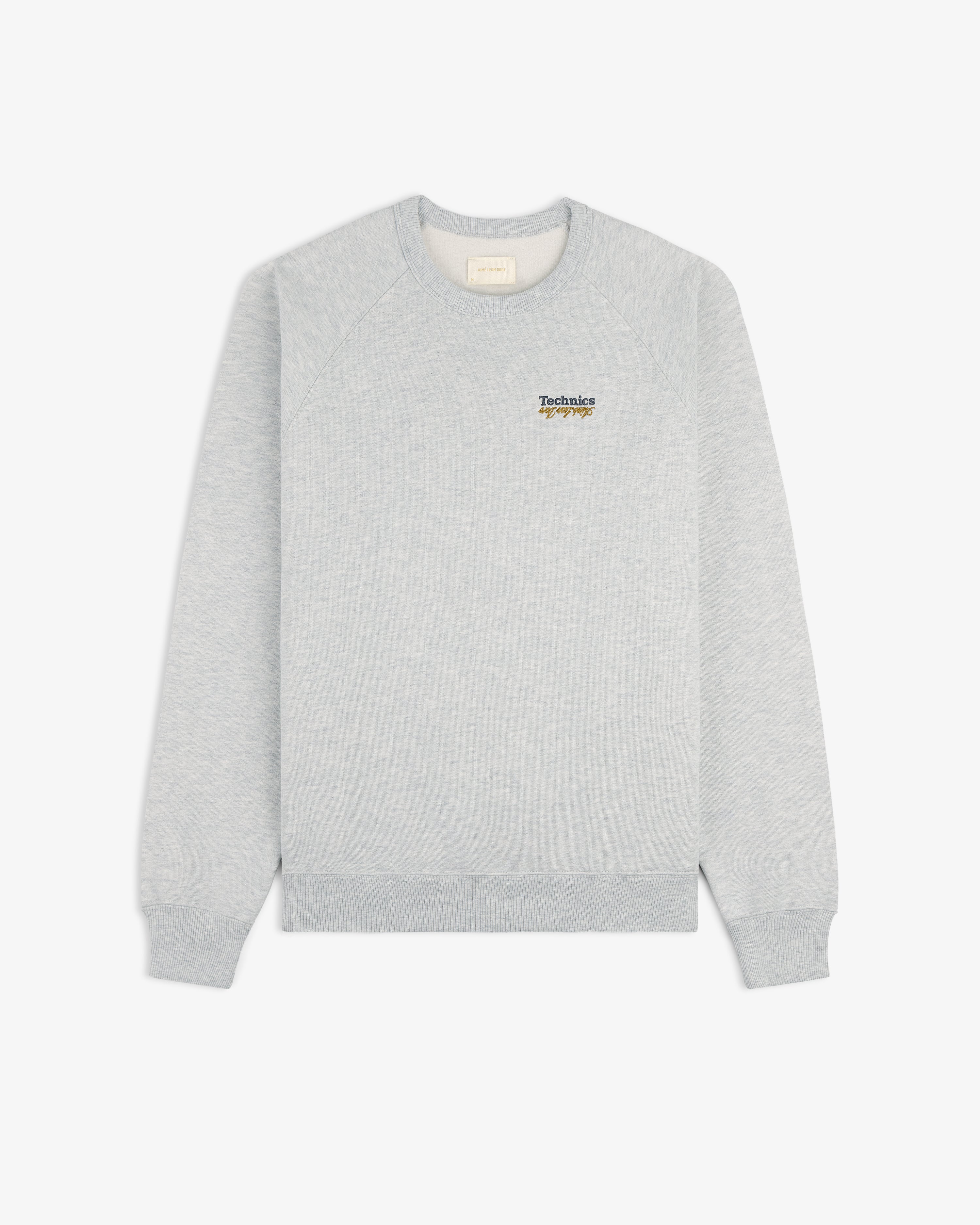 Light gray ALD / Technics World Champions Crewneck with small logo graphic on upper left chest, shown on white background.