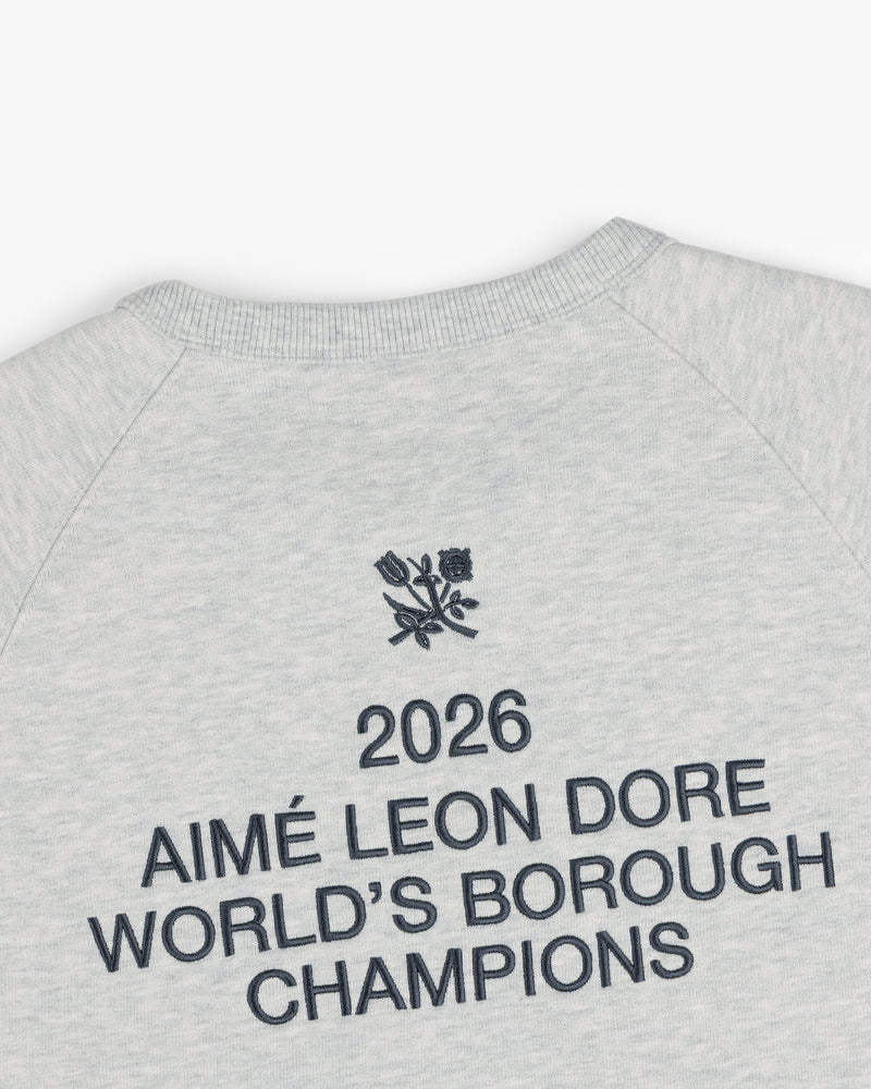 Light grey ALD / Technics World Champions Crewneck with “2026 AIMÉ LEON DORE WORLDS BOROUGH CHAMPIONS” and floral emblem.