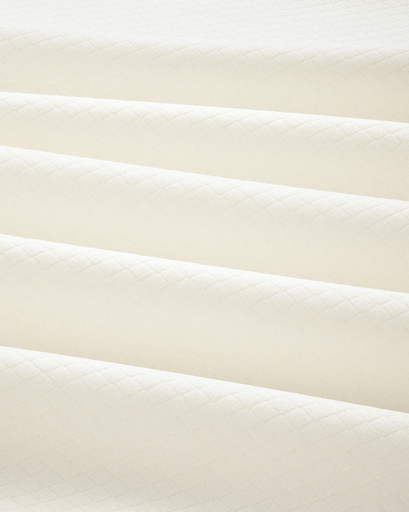 Cream-colored ALD Golf Quarter Zip Pullover in quilted fabric with a subtle diamond pattern and soft, even folds.