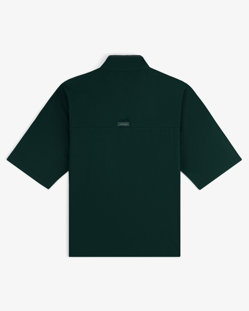 Dark green ALD Golf Quarter Zip Pullover shown from the back with a small brand tag below the collar.