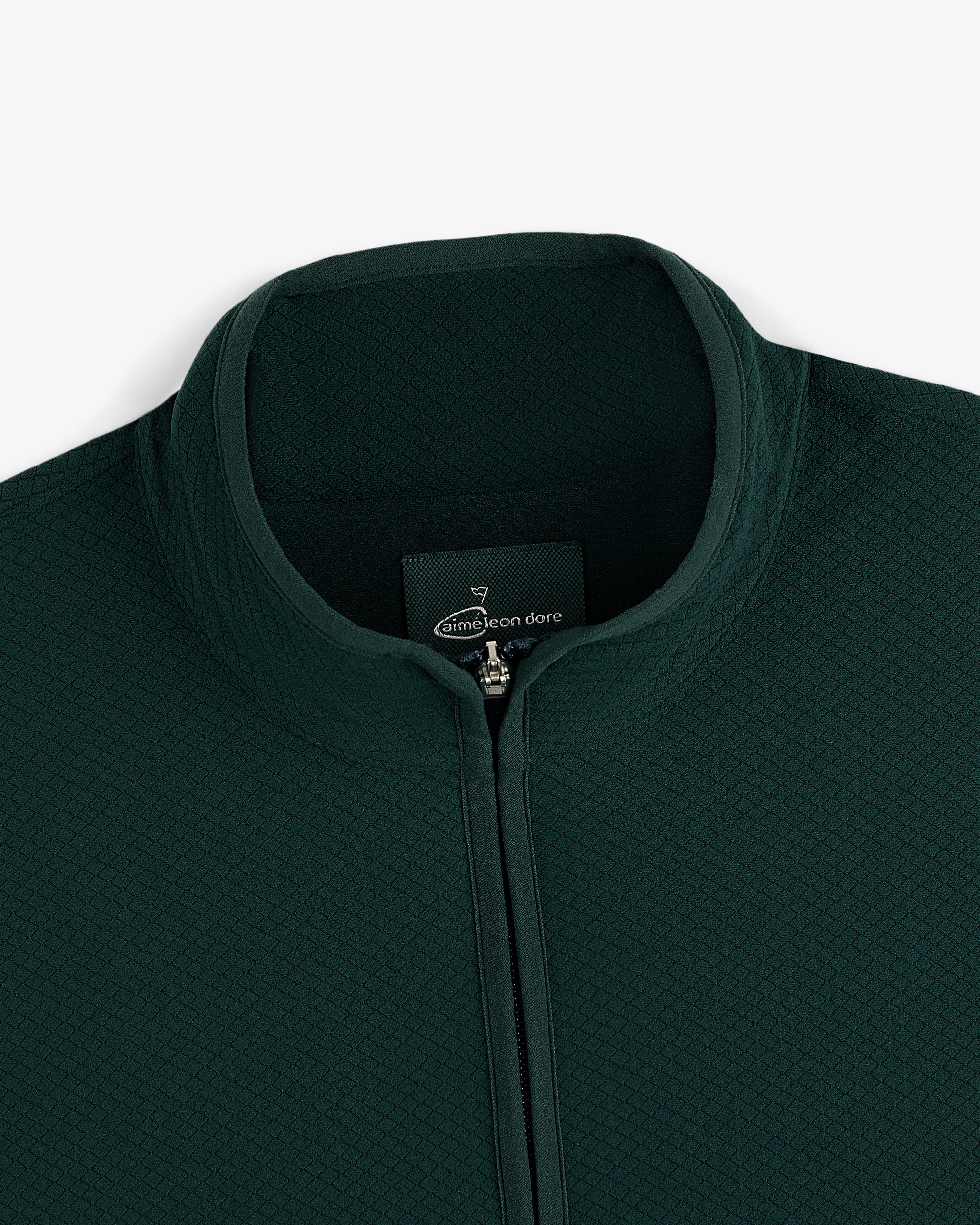 ALD Golf Quarter Zip Pullover in dark green with textured fabric and stand collar, shown neck down on white background.