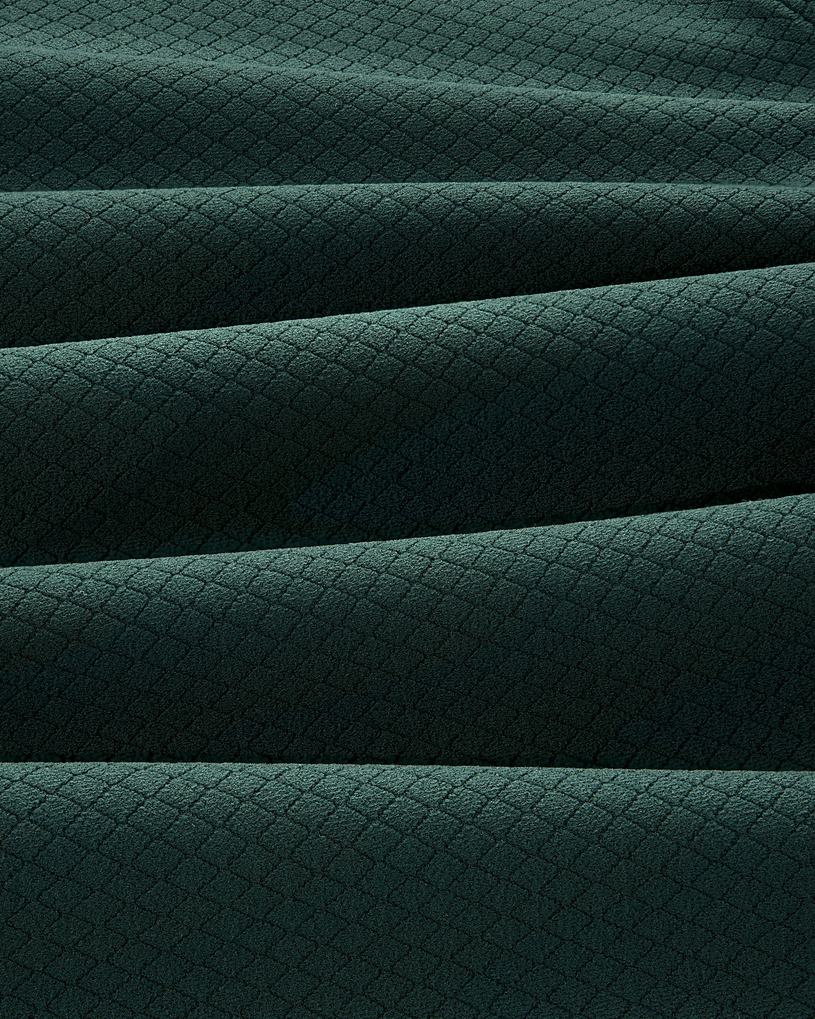 The ALD Golf Quarter Zip Pullover features dark green fabric with a subtle diamond pattern and soft horizontal pleats.