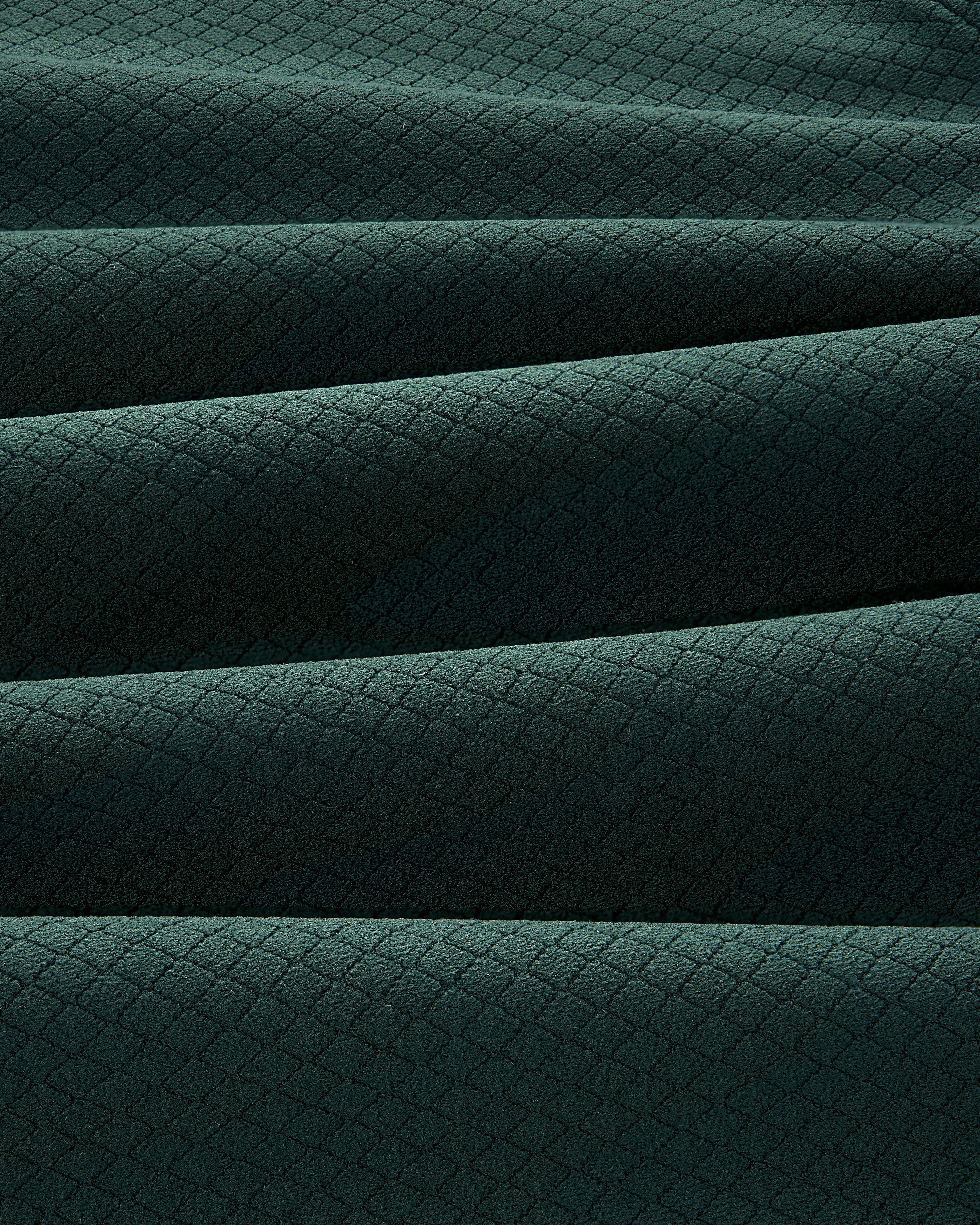 The ALD Golf Quarter Zip Pullover features dark green fabric with a subtle diamond pattern and soft horizontal pleats.