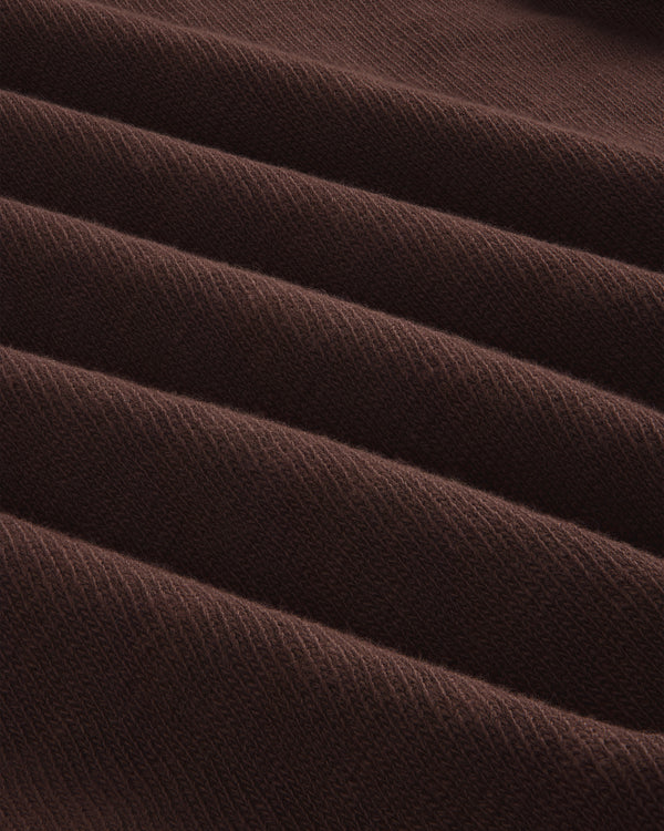 Close-up of Long-Sleeve Slub Football Tee in dark brown, showing ribbed fabric with diagonal texture and repeating ridges.