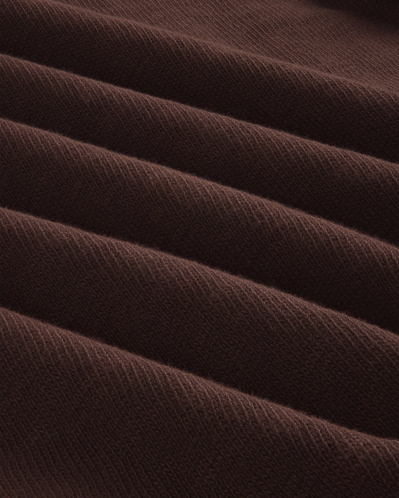Close-up of Long-Sleeve Slub Football Tee in dark brown, showing ribbed fabric with diagonal texture and repeating ridges.