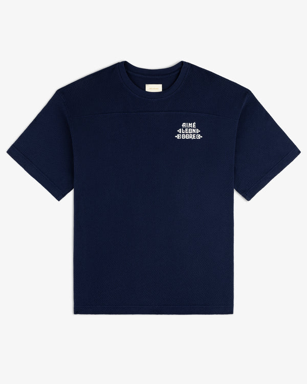 Navy blue Pointelle Stacked Logo Tee with a small white logo on the upper left chest.