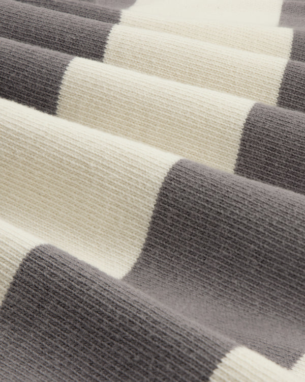 Close-up of the Striped Crest Rugby fabric featuring wide cream and gray horizontal stripes.