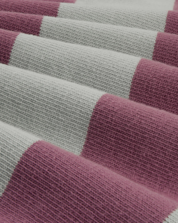 Close-up of the Striped Crest Rugby, featuring wide alternating light gray and mauve knitted stripes.