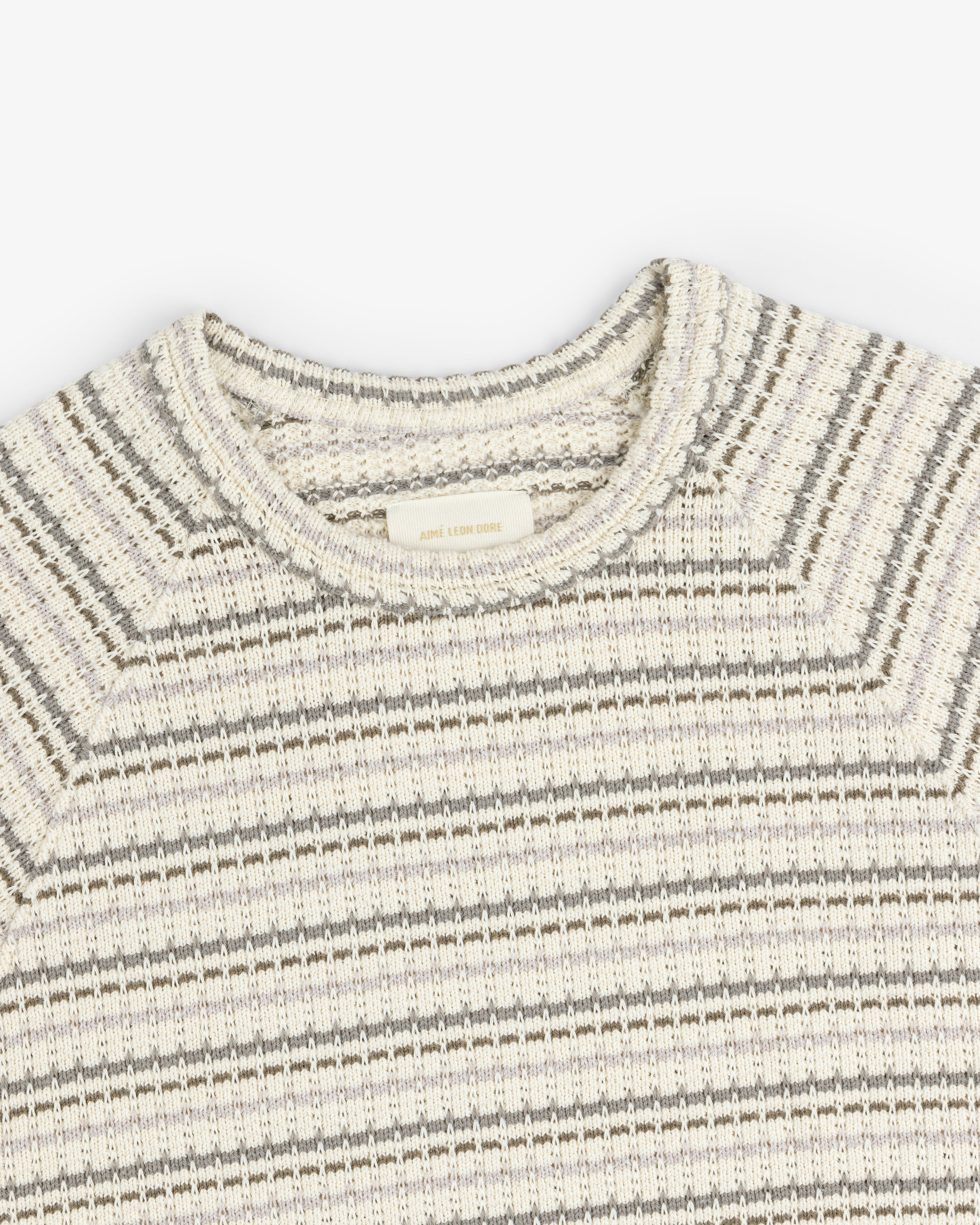 Jacquard Striped Tee in cream and gray with a ribbed crew neck, shown from the top front on a white background.