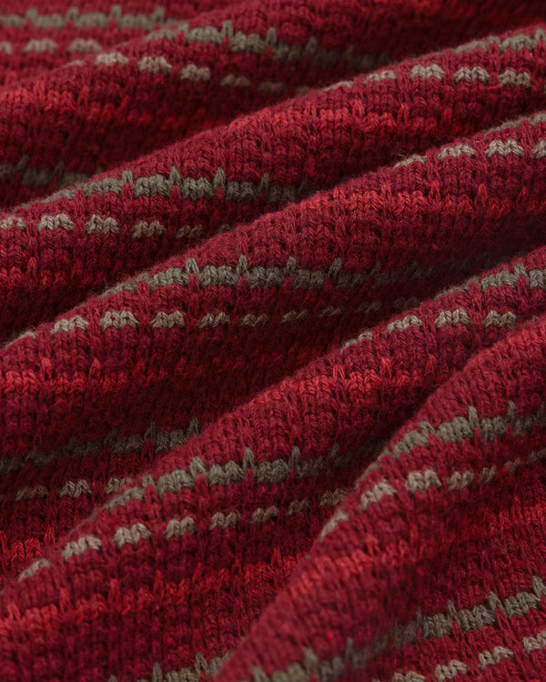 Close-up of Jacquard Striped Tee in red and gray, featuring a textured knit pattern with soft folds.
