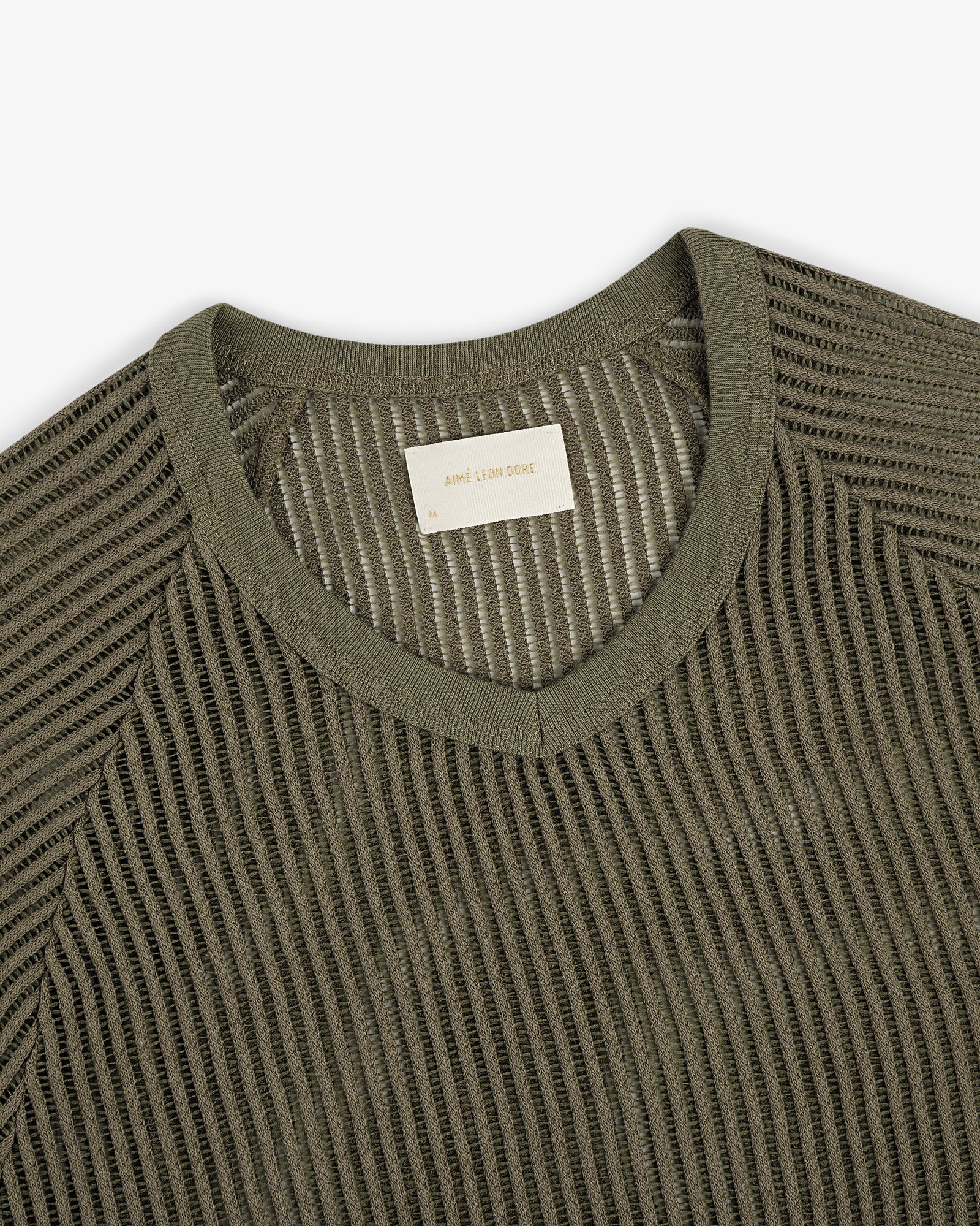 Olive green mesh V-neck tee featuring a visible woven label inside the collar.