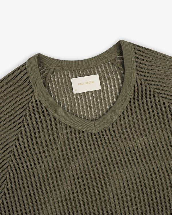 Olive green mesh V-neck tee featuring a visible woven label inside the collar.