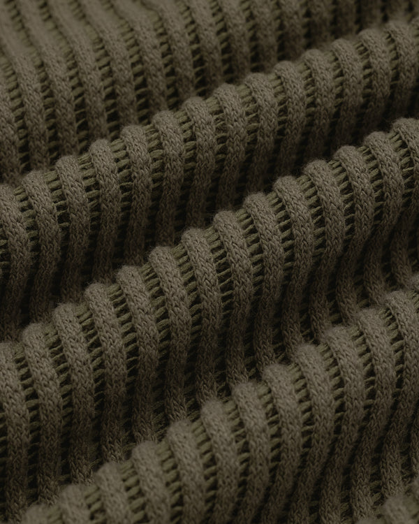 Close-up of olive green ribbed knit on the Mesh V-Neck Tee, showing horizontal ridges and textured detail.