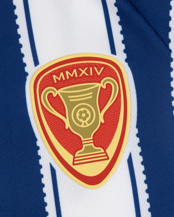 Gold trophy badge with MMXIV on red, attached to Aimé Cup Soccer Jersey's blue and white stripes.