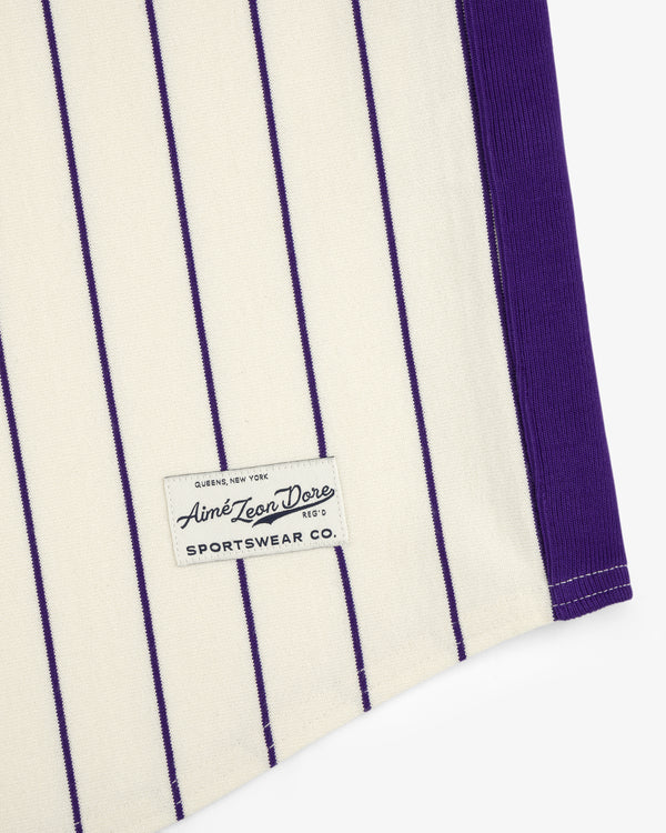 Cream Aimé Baseball Jersey with thin purple stripes and a black "Aime Leon Dore SPORTWEAR CO." sewn label.