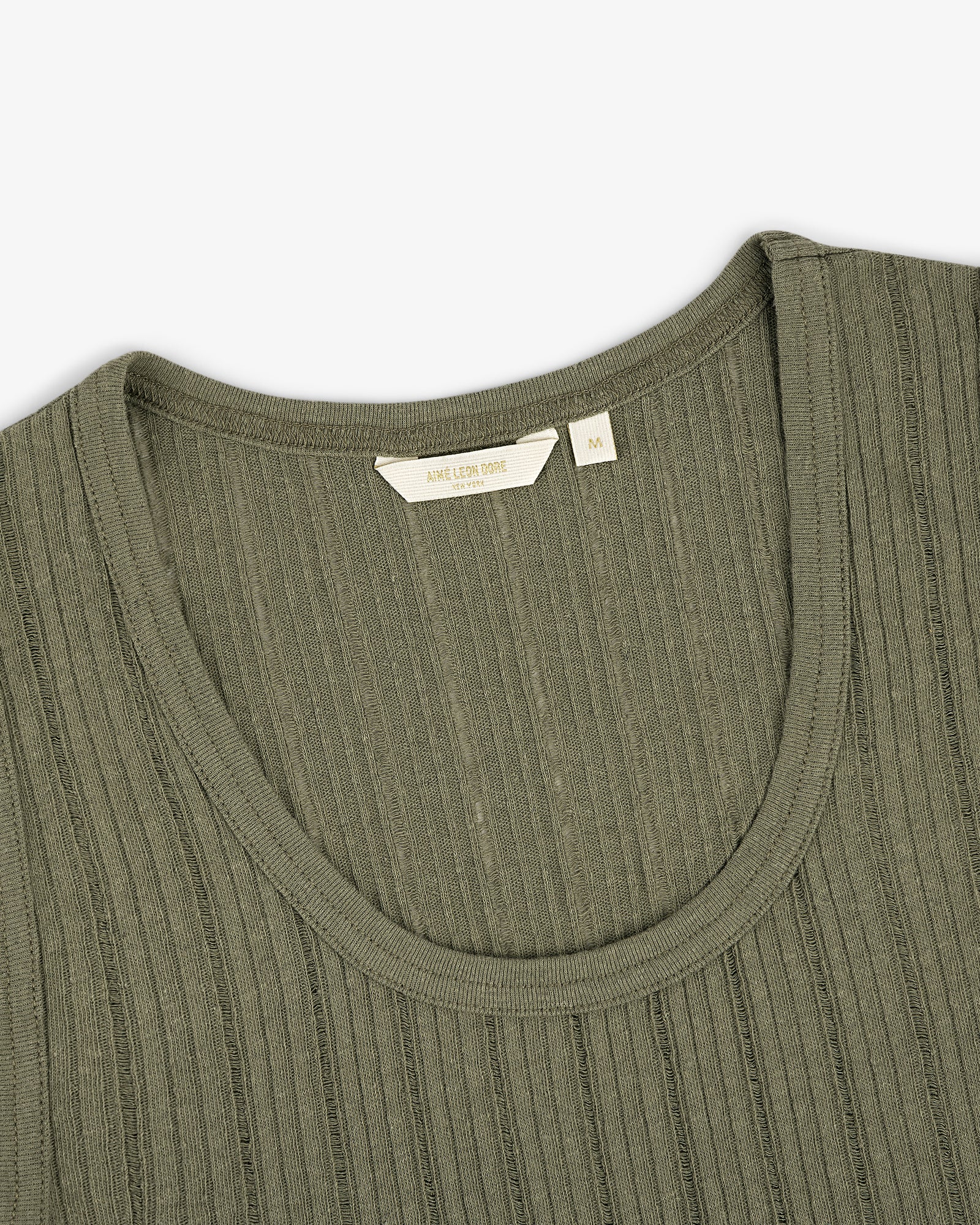 Close-up of the Drop Needle Tank Top in olive green with ribbed knit, round neckline, and visible size tag.