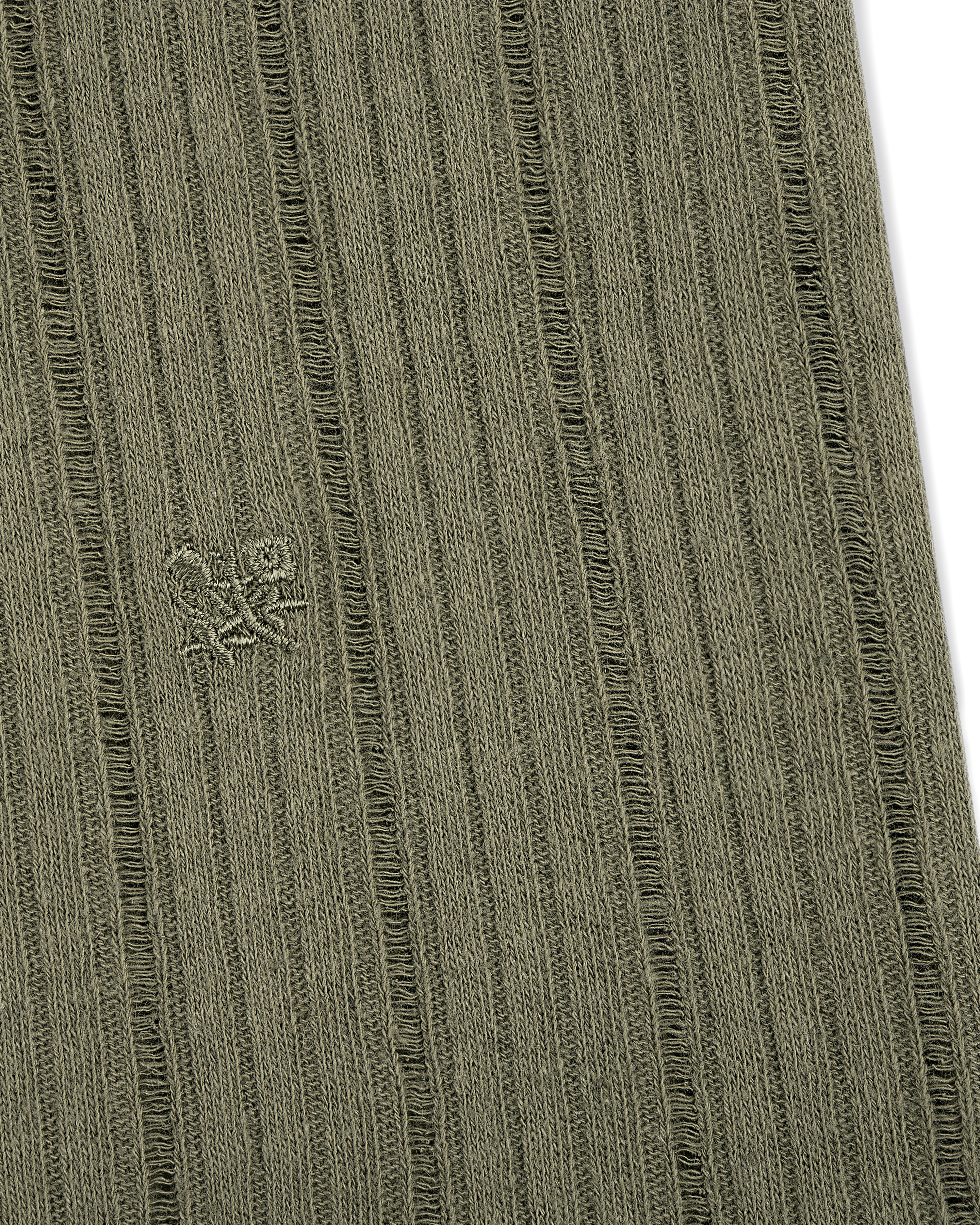 Close-up of olive green Drop Needle Tank Top's ribbed fabric with a small embroidered logo of two abstract shapes.