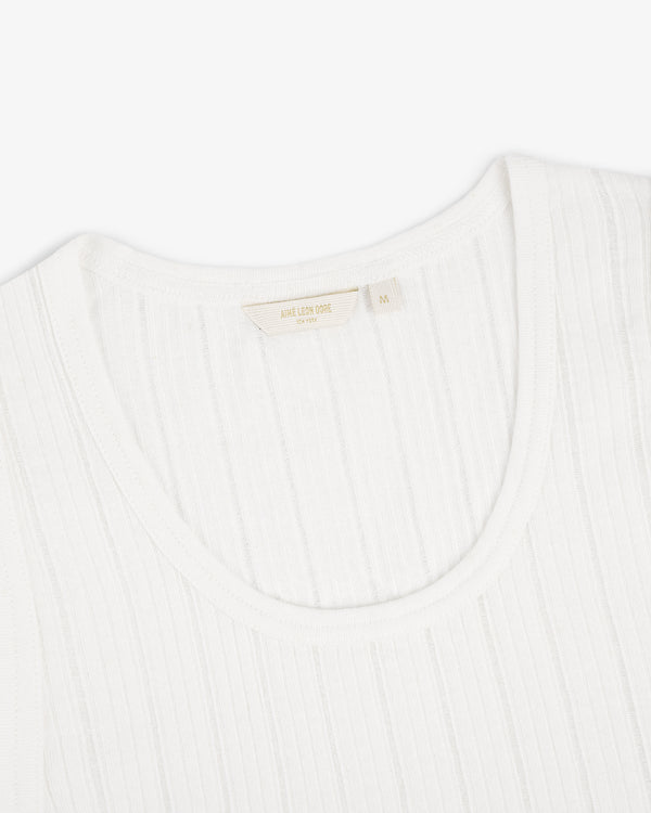 Close-up of a Drop Needle Tank Top with a fabric label inside the collar, photographed on a white background.