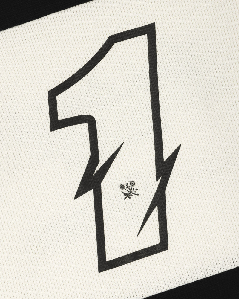 A bold, black number 1 with zigzag edges and a flower sits on the Long-Sleeve Mesh Enduro Tee’s textured white fabric.