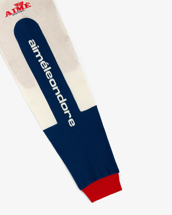 A blue, cream, and red Long-Sleeve Mesh Enduro Tee with aimeleondore text and a red AIMÉ logo on white background.