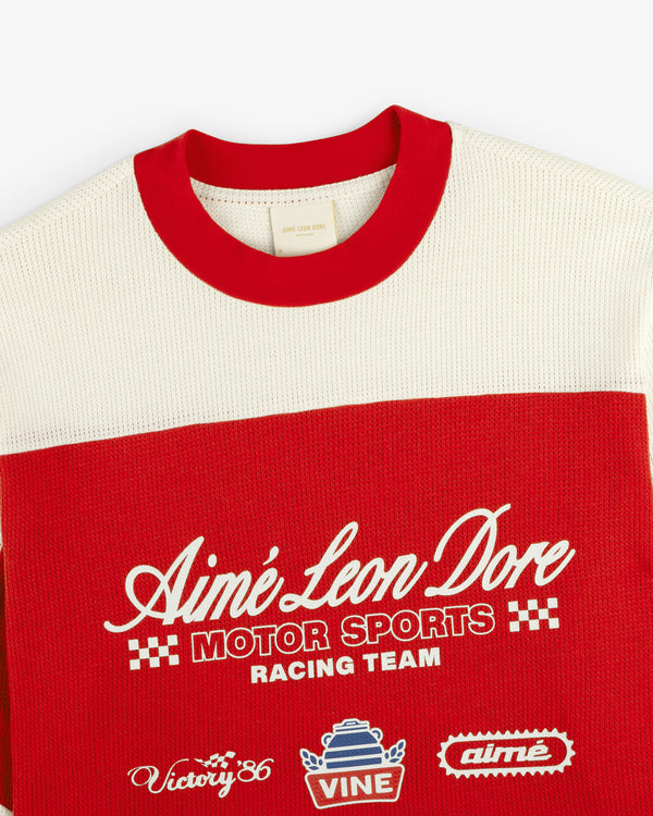 Red and cream Aimé Leon Dore Long-Sleeve Mesh Enduro Tee with embroidered logos, checkers, and racing graphics.