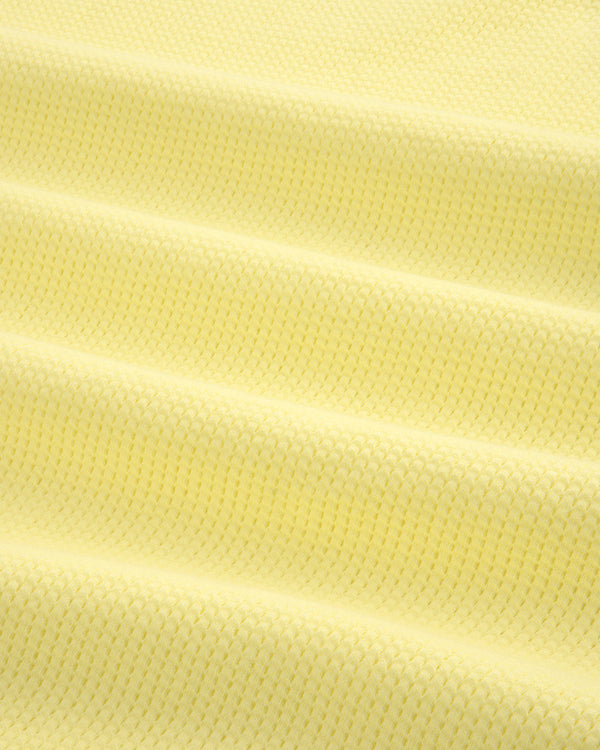 Close-up of the Mesh Muscle Tank in light yellow, showing its textured fabric and subtle horizontal folds.