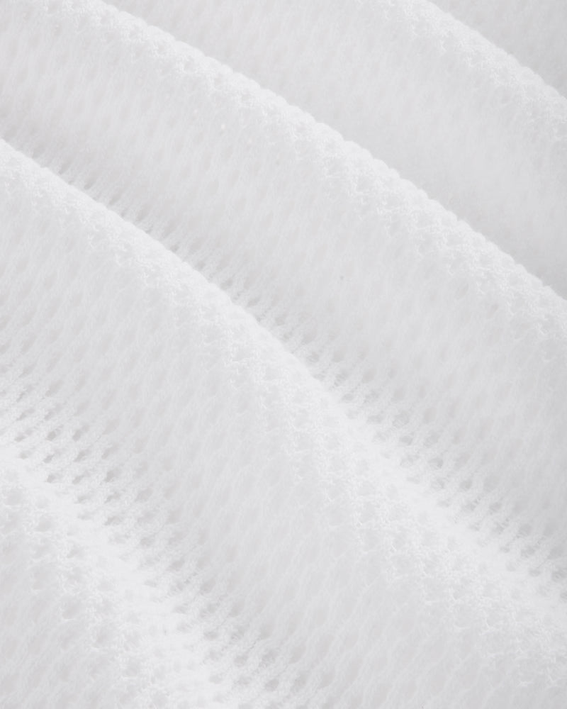 Close-up of the Mesh Tank Top's white textured fabric featuring a soft, quilted, diagonal wavy pattern.