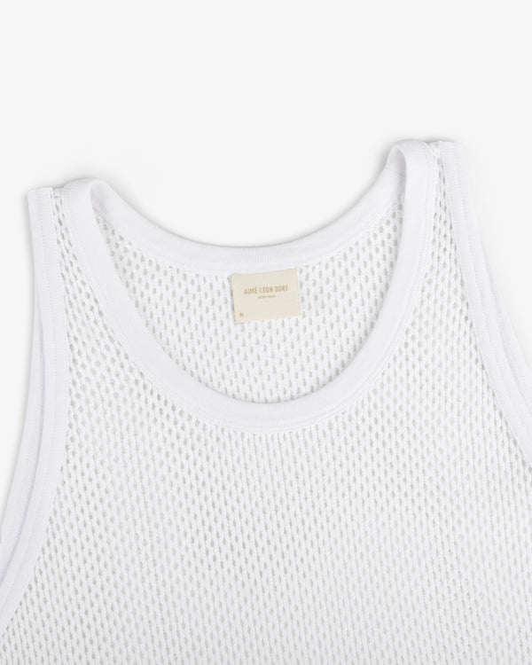 Close-up of Mesh Tank Top in white with ribbed edges and a beige neck label, shown on a white background.