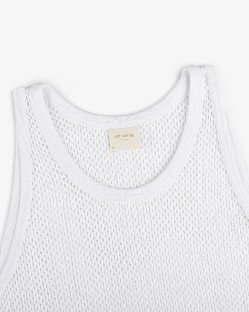 Close-up of Mesh Tank Top in white with ribbed edges and a beige neck label, shown on a white background.