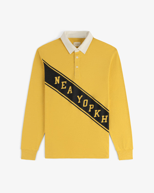 The Vintage Slub Rugby is a yellow long-sleeve polo with a white collar and NEA YOPKH on a diagonal black stripe front.