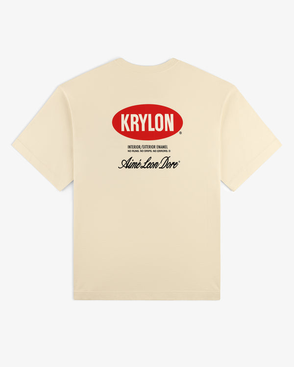 Back of beige Krylon Logo Tee with red KRYLON logo and black Aimé Leon Dore text printed below.