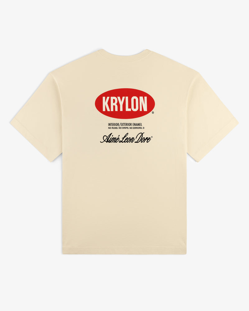 Back of beige Krylon Logo Tee with red KRYLON logo and black Aimé Leon Dore text printed below.