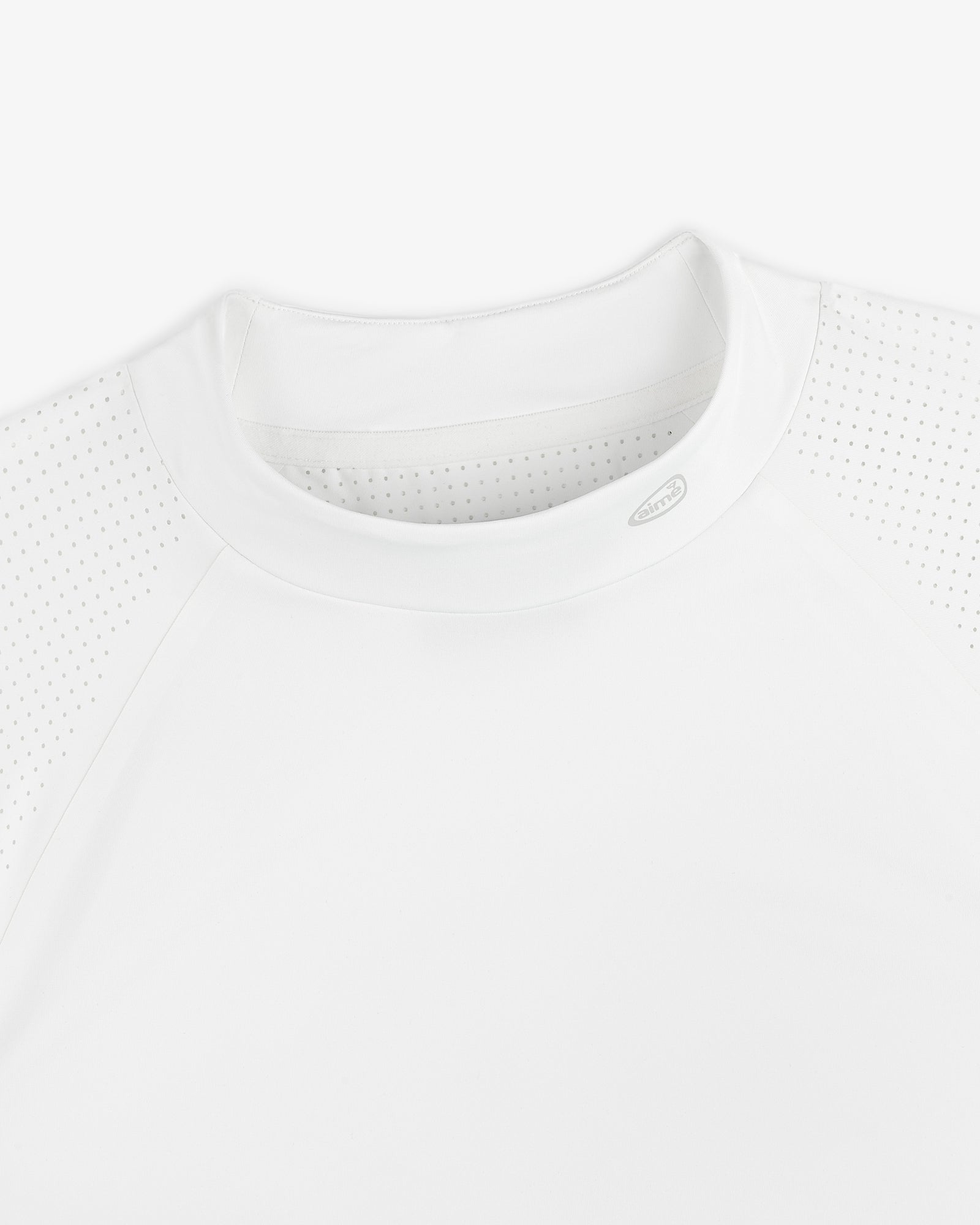 Close-up of the ALD Golf Performance Tee, featuring perforated raglan sleeves and a crew neck on a white background.