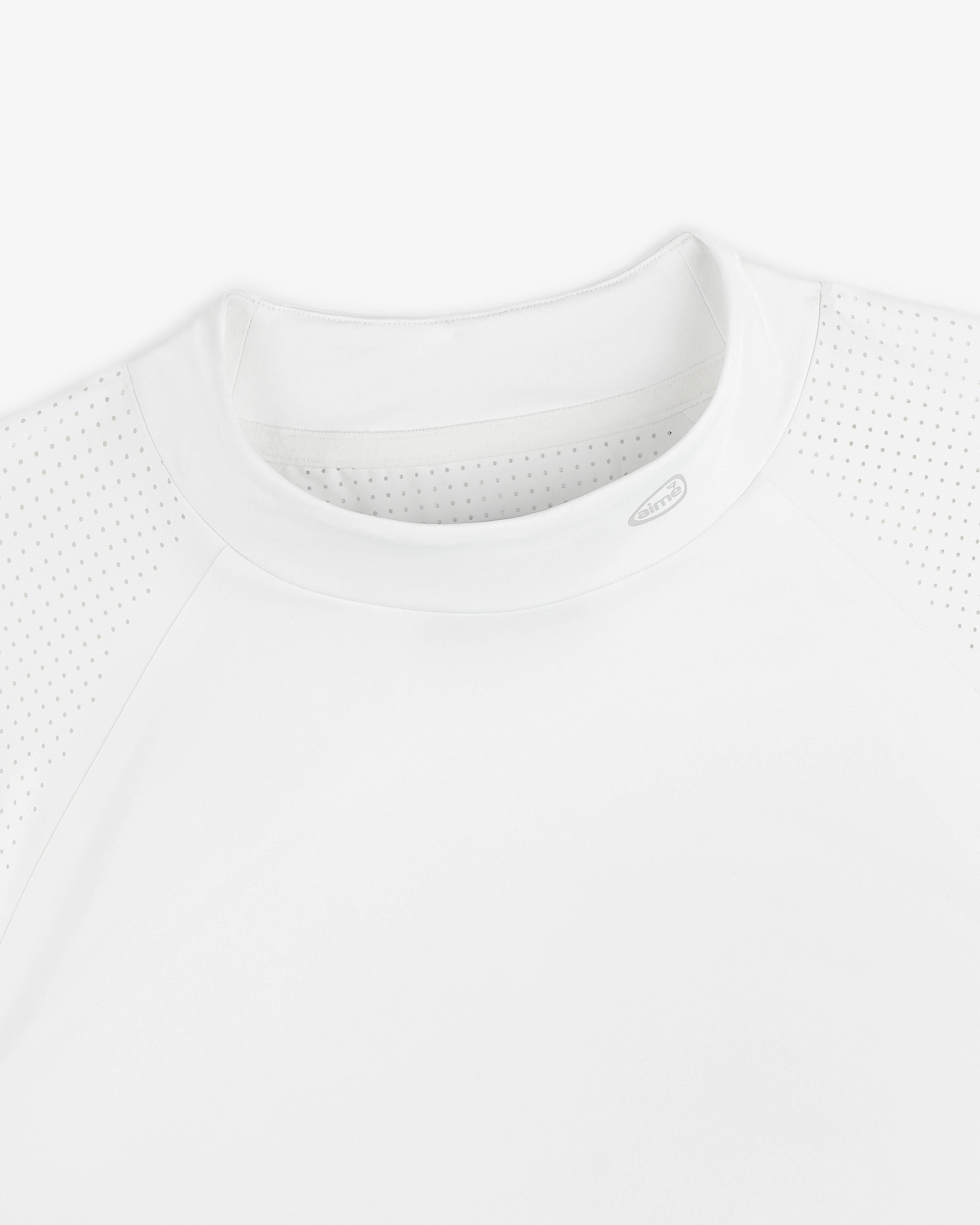 Close-up of the ALD Golf Performance Tee, featuring perforated raglan sleeves and a crew neck on a white background.
