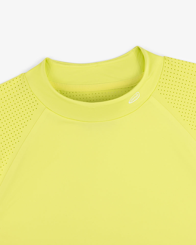 Close-up of the ALD Golf Performance Tee in yellow, featuring perforated sleeves and a round neck on white background.