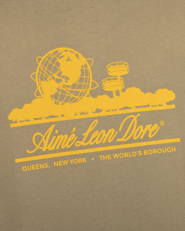 Sun Faded Unisphere Tee: Yellow Aimé Leon Dore globe logo, Queens landmarks, "Queens, New York - The Worlds Borough" on khaki.