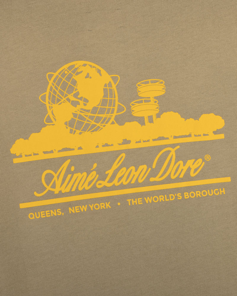 Sun Faded Unisphere Tee: Yellow Aimé Leon Dore globe logo, Queens landmarks, "Queens, New York - The Worlds Borough" on khaki.