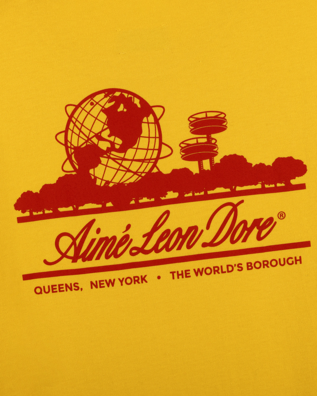 Red graphic of globe, trees, Unisphere & text on yellow Sun Faded Unisphere Tee by Aime Leon Dore, Queens, NY.