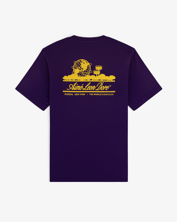 The Sun Faded Unisphere Tee is a purple t-shirt with a yellow Unisphere graphic and Aimé Leon Dore text referencing Queens, NY.