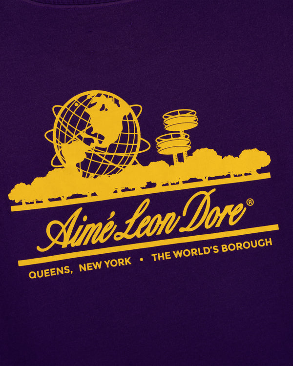 Yellow Aimé Leon Dore globe logo and NY landmarks on purple Sun Faded Unisphere Tee. Text: Queens, New York.